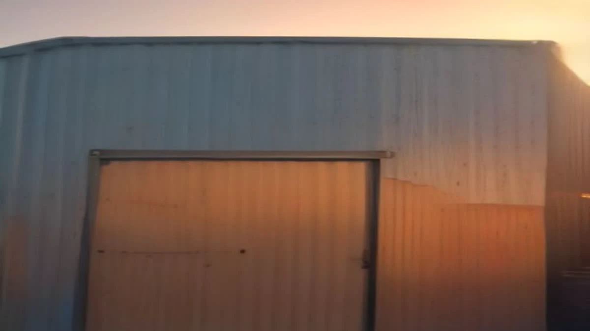 over-the-shoulder view of a shipping container yard at golden hour with cranes in the background, used as the opening image
